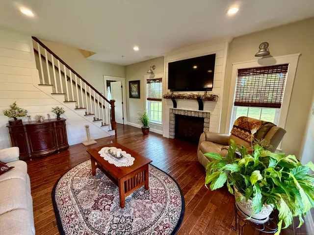 a living room with furniture fireplace and a flat screen tv