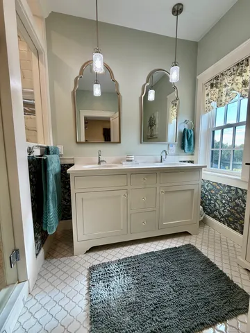 a bathroom with a sink a vanity and a mirror
