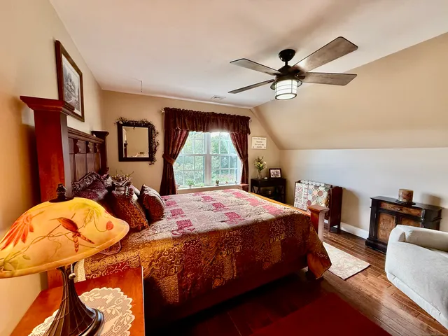 a bedroom with bed and a chandelier