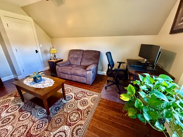 a living room with furniture and a potted plant