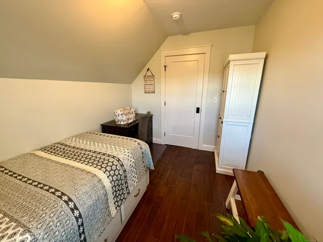 a bedroom with a bed and a mirror