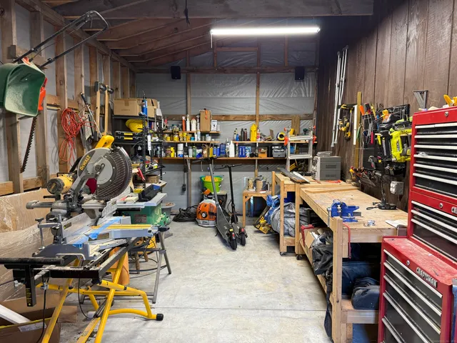 a storage room with washer and chairs