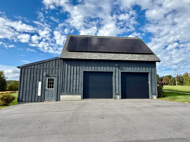 a front view of a house with a garden and yard