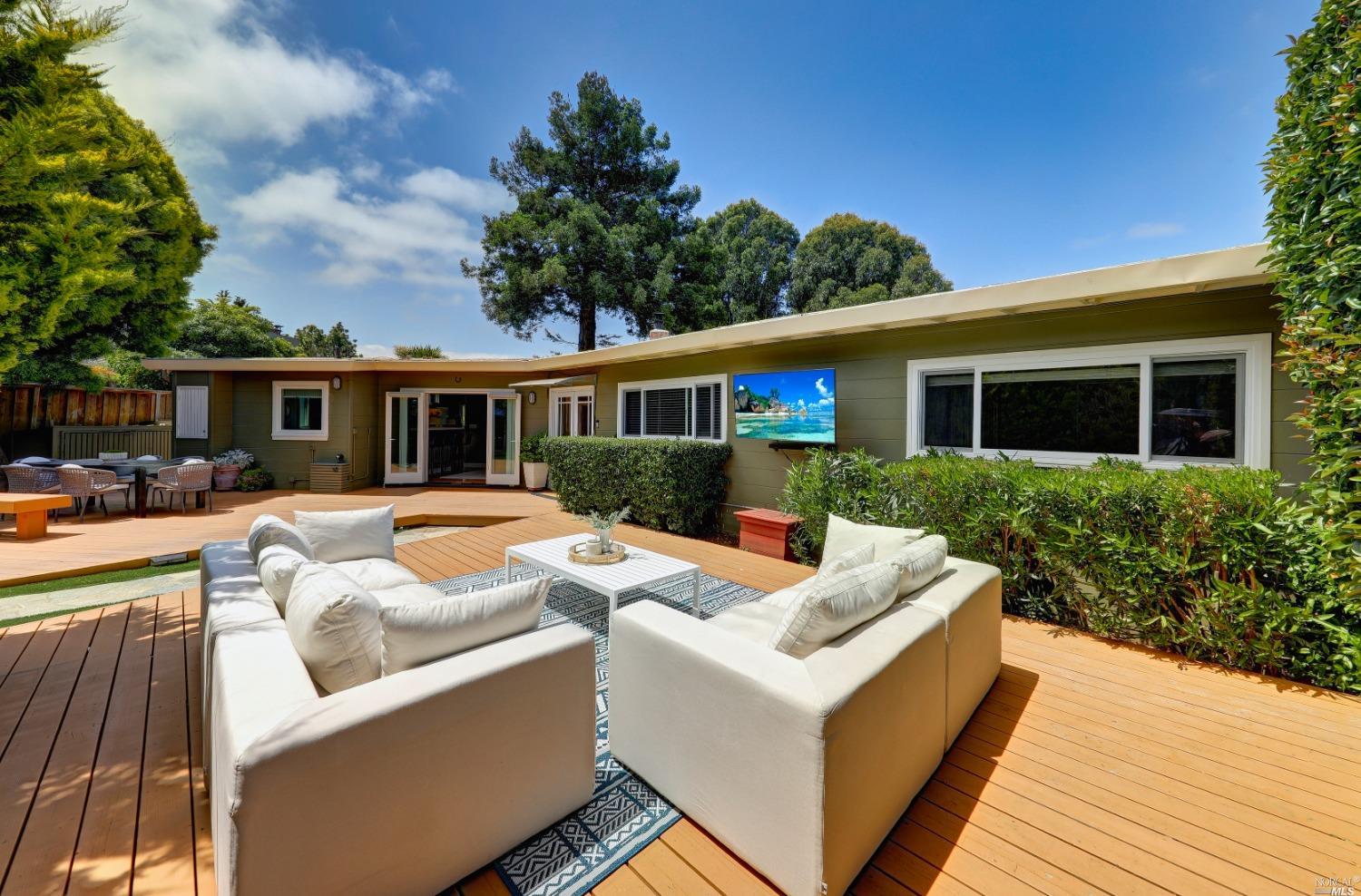 a view of house with swimming pool and furniture