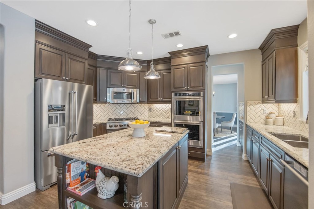 30177 Sagecrest Way Castaic, CA 91384 - Photo 14 of 54 a kitchen with stainless steel appliances granite countertop a refrigerator a stove and a sink