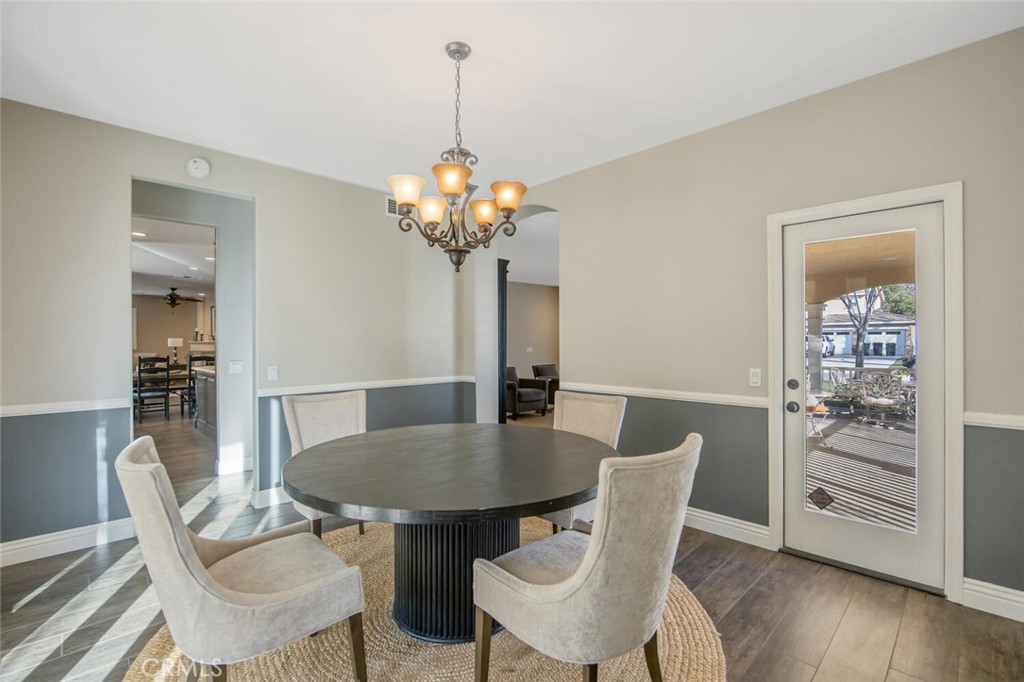 30177 Sagecrest Way Castaic, CA 91384 - Photo 20 of 54 a view of a dining room with furniture wooden floor and chandelier