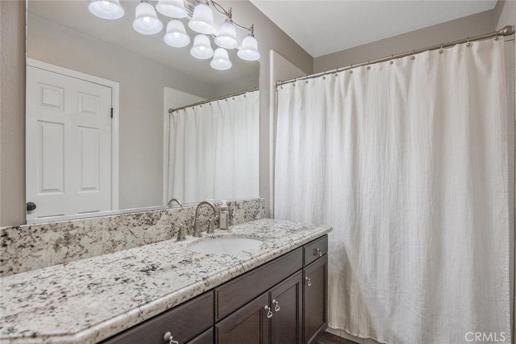 30177 Sagecrest Way Castaic, CA 91384 - Photo 22 of 54 a bathroom with a granite countertop sink and a mirror