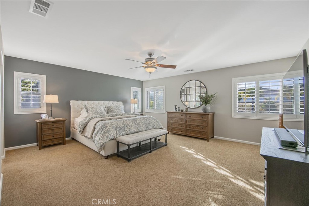 30177 Sagecrest Way Castaic, CA 91384 - Photo 25 of 54 a spacious bedroom with a bed a dresser and mirror