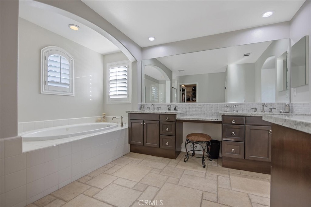 30177 Sagecrest Way Castaic, CA 91384 - Photo 26 of 54 a spacious bathroom with a granite countertop sink a mirror and a bathtub