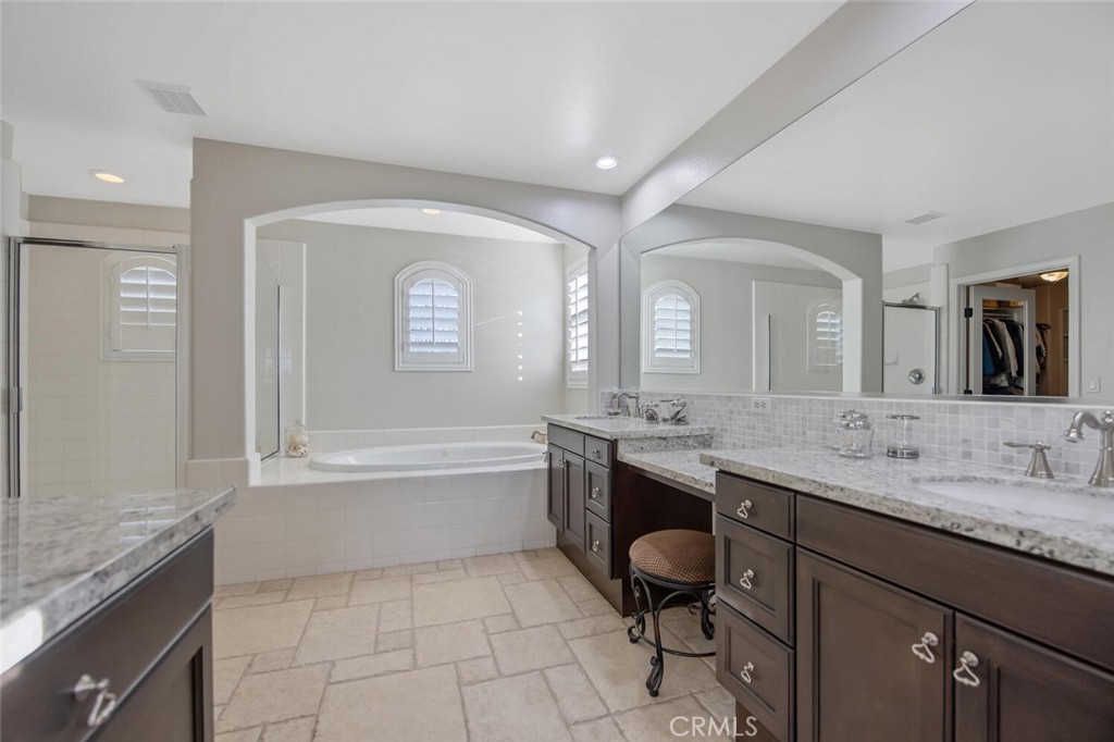 30177 Sagecrest Way Castaic, CA 91384 - Photo 27 of 54 a bathroom with a granite countertop sink mirror and bathtub