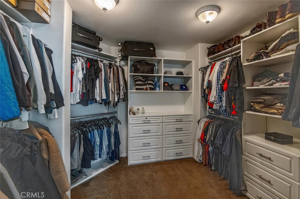 30177 Sagecrest Way Castaic, CA 91384 - Photo 28 of 54 a view of walk in closet with clothes and shoes