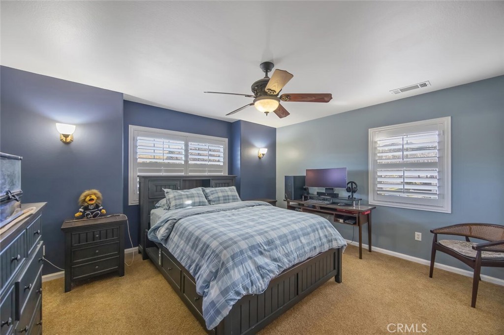 30177 Sagecrest Way Castaic, CA 91384 - Photo 29 of 54 a bedroom with a bed and a table in it