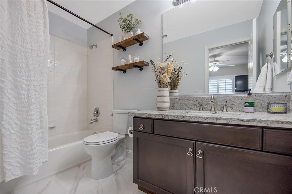 30177 Sagecrest Way Castaic, CA 91384 - Photo 30 of 54 a bathroom with a granite countertop sink toilet and mirror