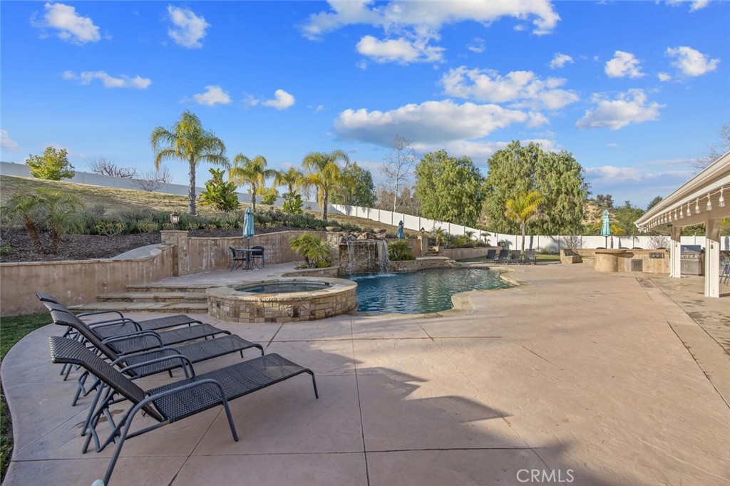 30177 Sagecrest Way Castaic, CA 91384 - Photo 43 of 54 a view of a patio with couches and table and chairs with wooden fence
