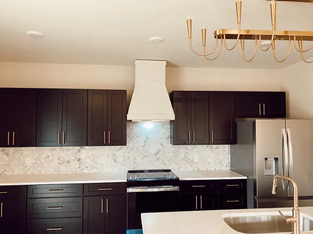 a kitchen with a sink and a refrigerator