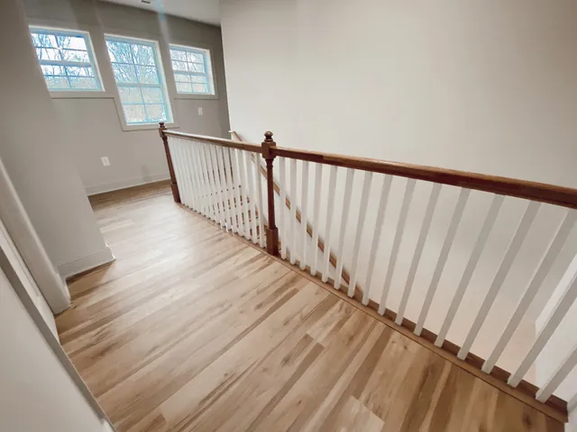 a view of a hallway with wooden floor