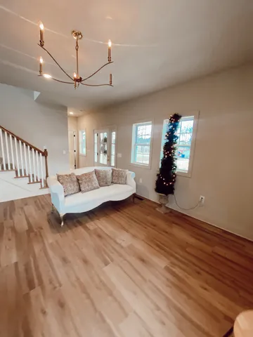 a living room with furniture and wooden floor