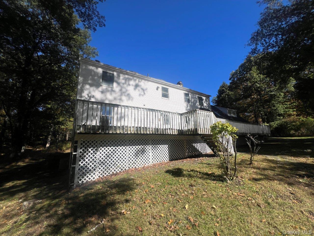 7 Felter Hill Road Monroe, NY 10950 - Photo 4 of 12 Rear view of house featuring a lawn and a wooden deck