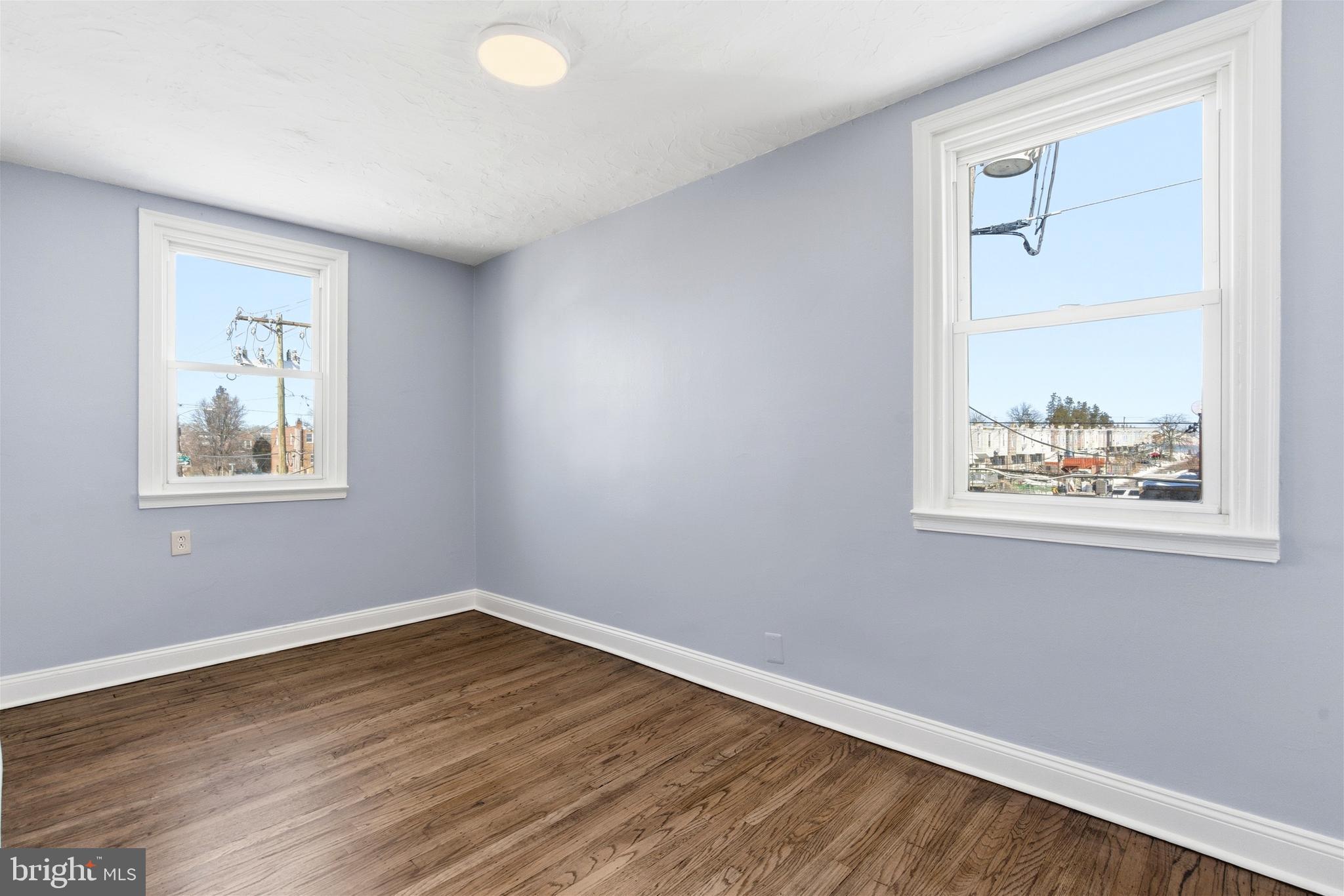 6266 Marsden Street Philadelphia, PA 19135 - Photo 13 of 27 a view of an empty room with wooden floor and a window