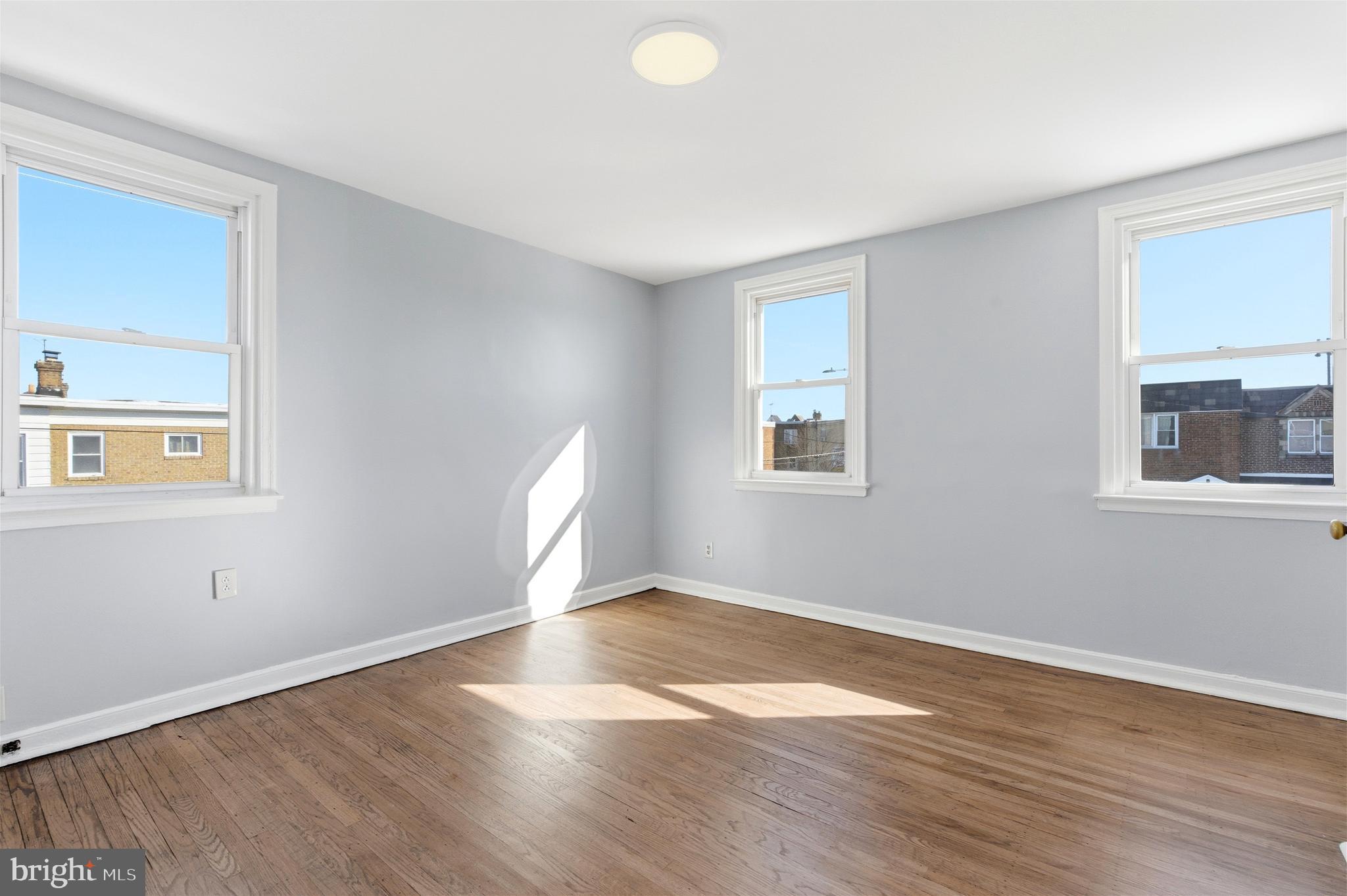 6266 Marsden Street Philadelphia, PA 19135 - Photo 17 of 27 a view of an empty room with wooden floor and a window