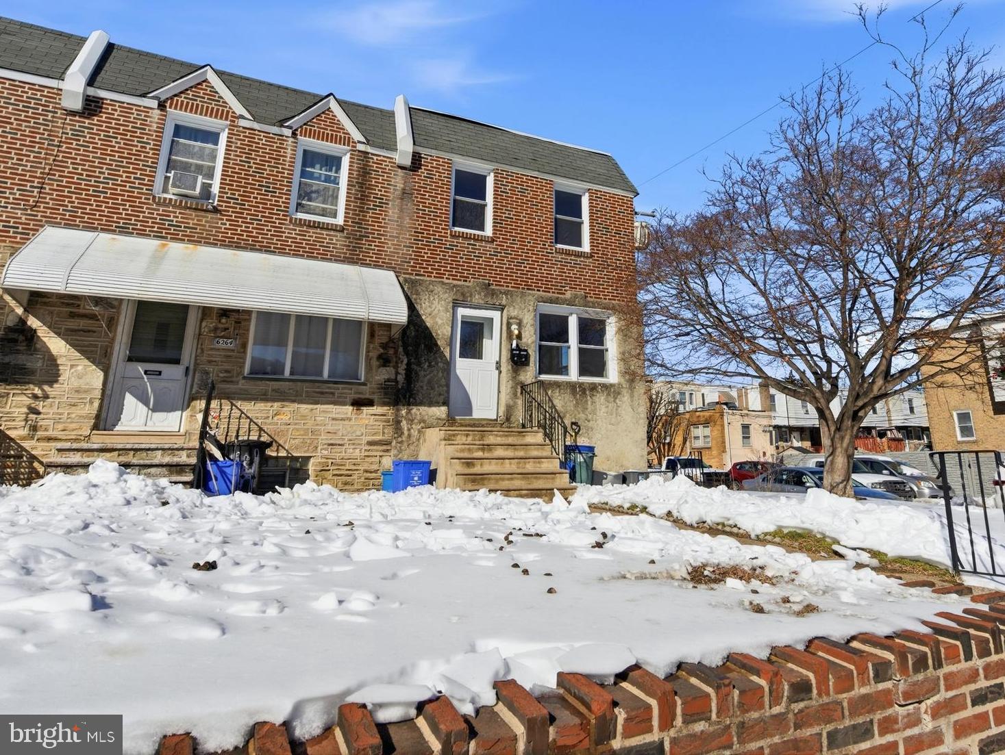 6266 Marsden Street Philadelphia, PA 19135 - Photo 19 of 27 a front view of a house with a yard covered in snow