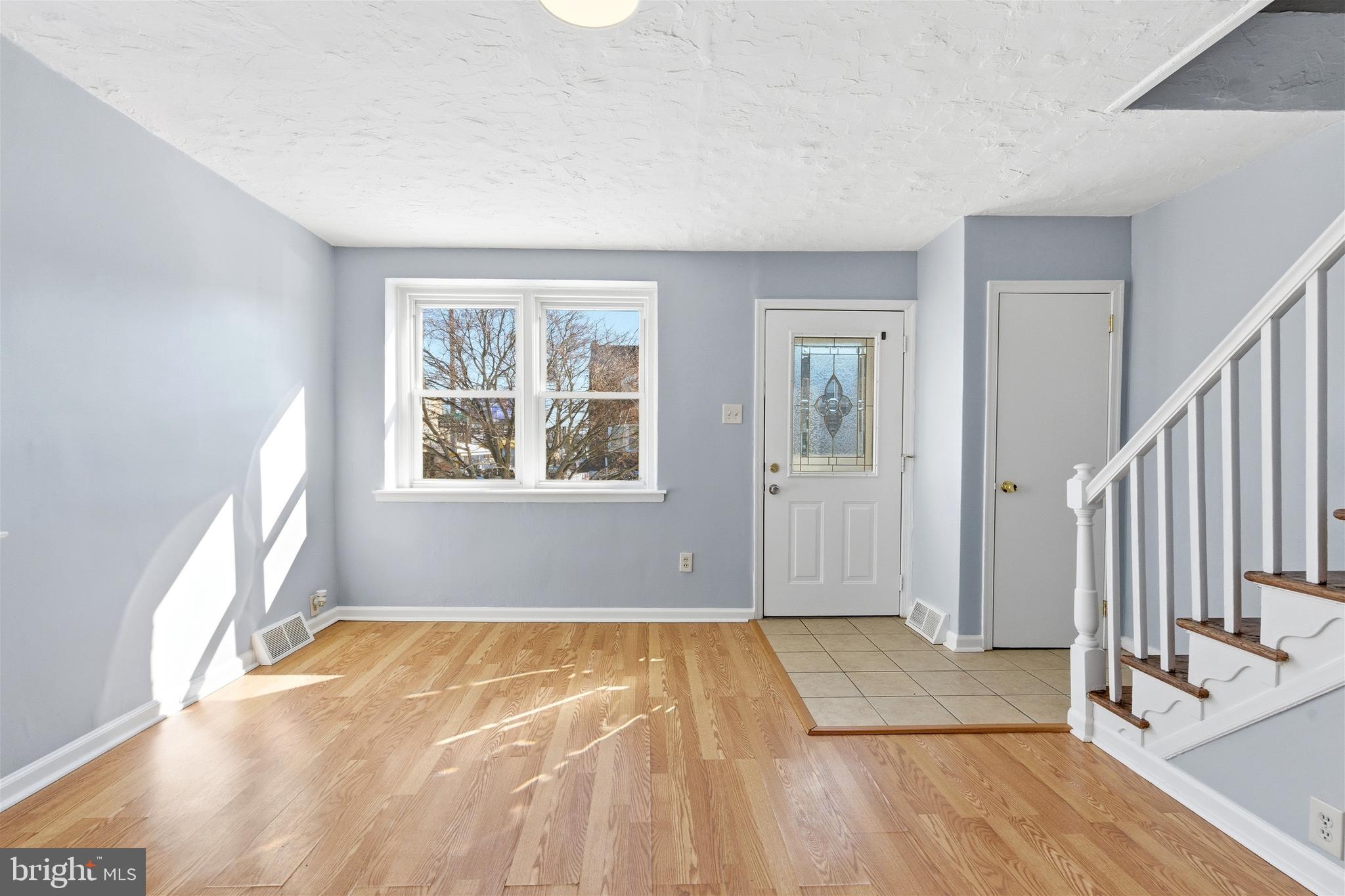 6266 Marsden Street Philadelphia, PA 19135 - Photo 6 of 27 a view of an empty room with wooden floor and a window
