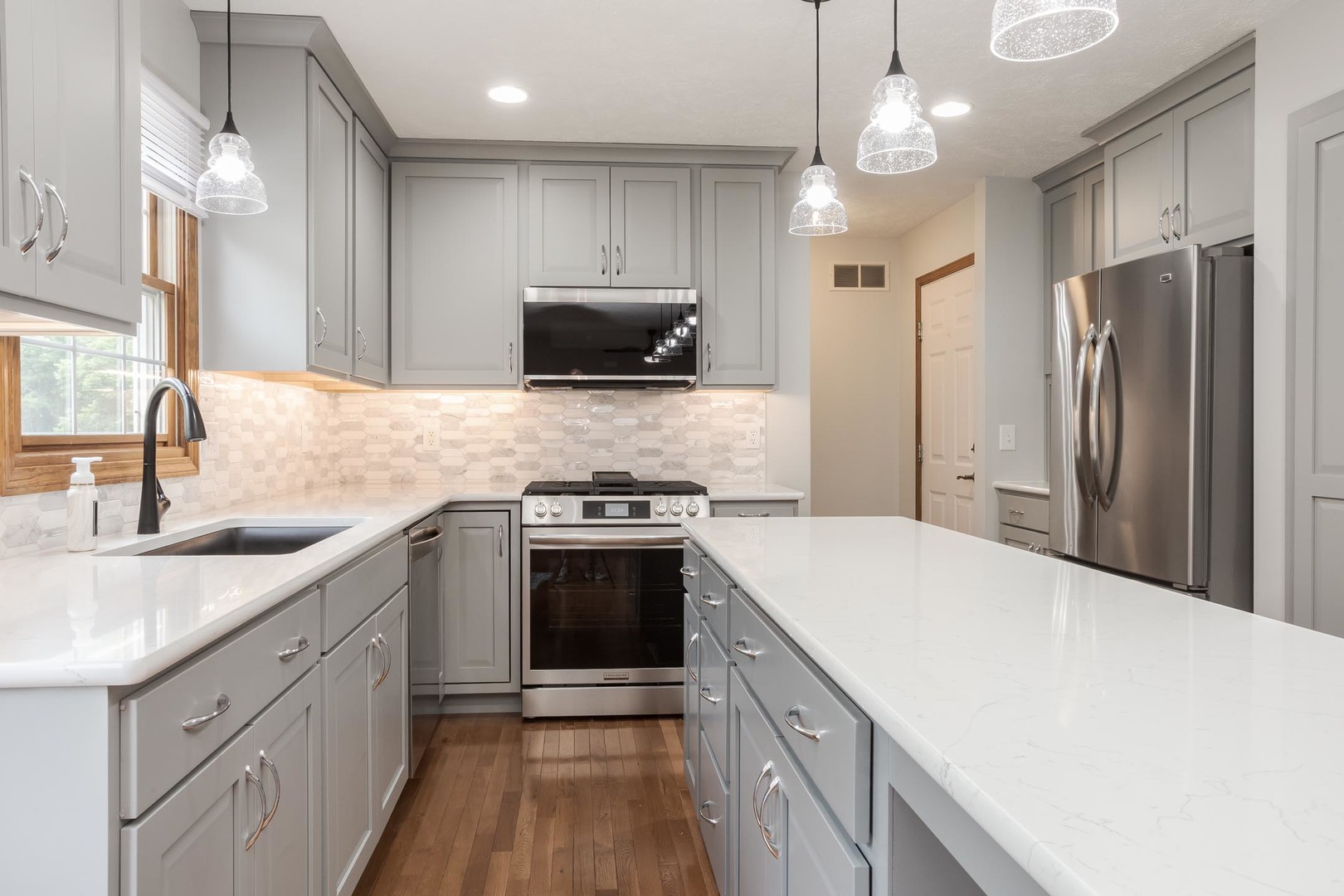 814 Landau Lane Normal, IL 61761 - Photo 22 of 58 a kitchen with kitchen island a sink stainless steel appliances and cabinets