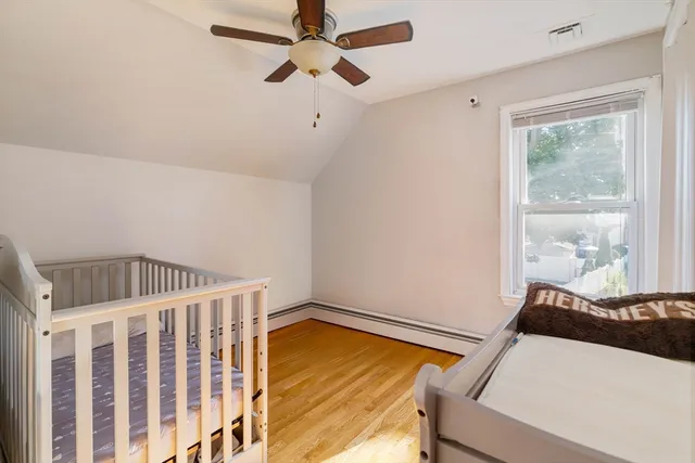 a view of a room with wooden floor and white walls