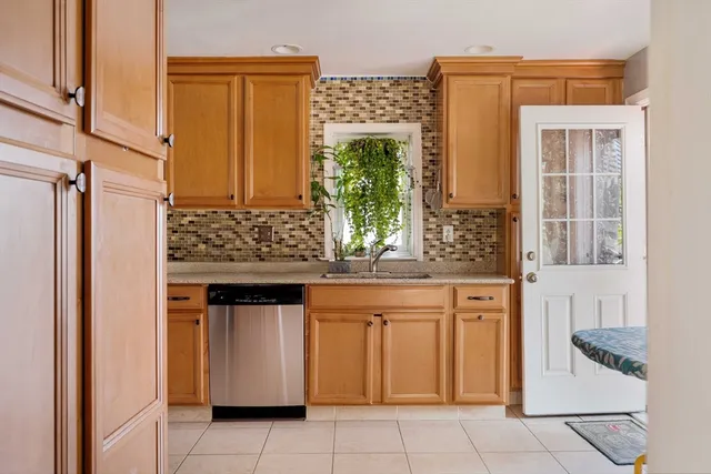 a kitchen with stainless steel appliances granite countertop a stove and a refrigerator