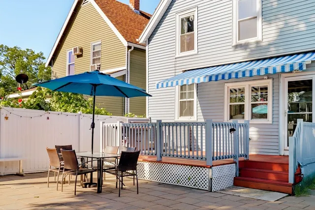 a view of a house with a deck and furniture