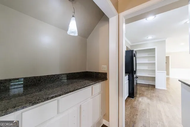 a view of n empty room with window and wooden floor