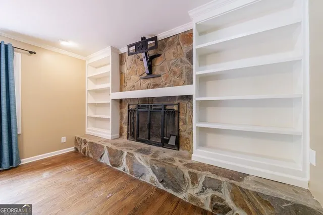 a view of a livingroom with wooden floor and window