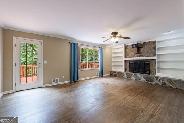 a kitchen with stainless steel appliances granite countertop a sink and cabinets with wooden floor