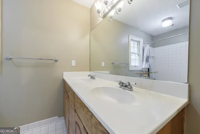 a bathroom with a glass shower door