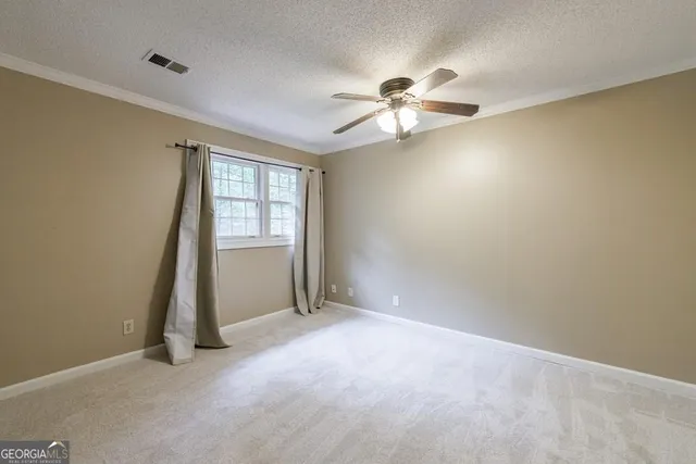 a view of a room with a large window and wooden floor