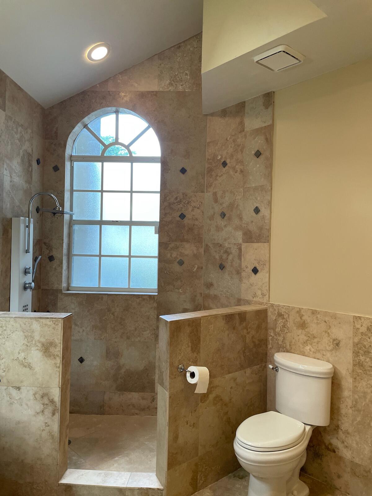 6675 Northwest 25th Way Boca Raton, FL 33496 - Photo 17 of 54 a bathroom with a toilet a sink and a shower