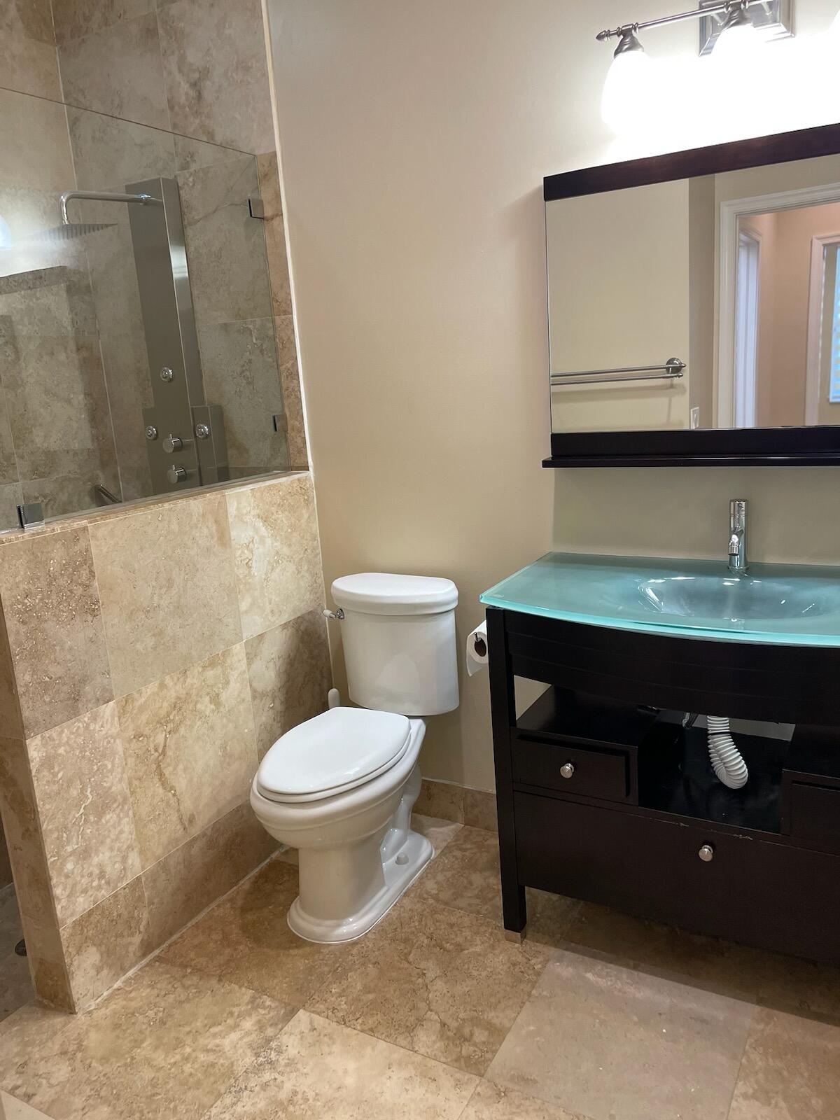 6675 Northwest 25th Way Boca Raton, FL 33496 - Photo 20 of 54 a bathroom with a toilet sink and mirror