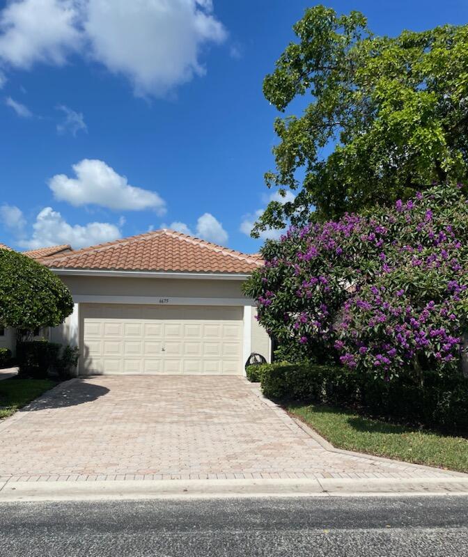 6675 Northwest 25th Way Boca Raton, FL 33496 - Photo 2 of 54 a house with a yard