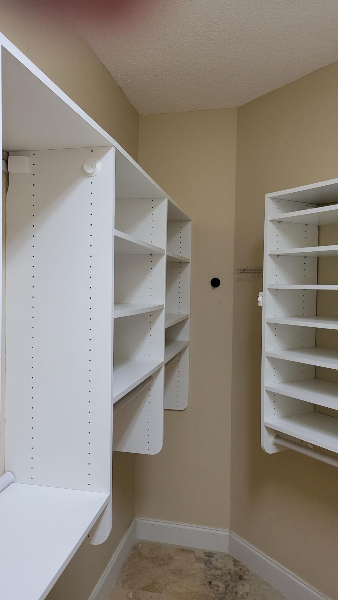 6675 Northwest 25th Way Boca Raton, FL 33496 - Photo 30 of 54 a view of walk in closet with empty racks