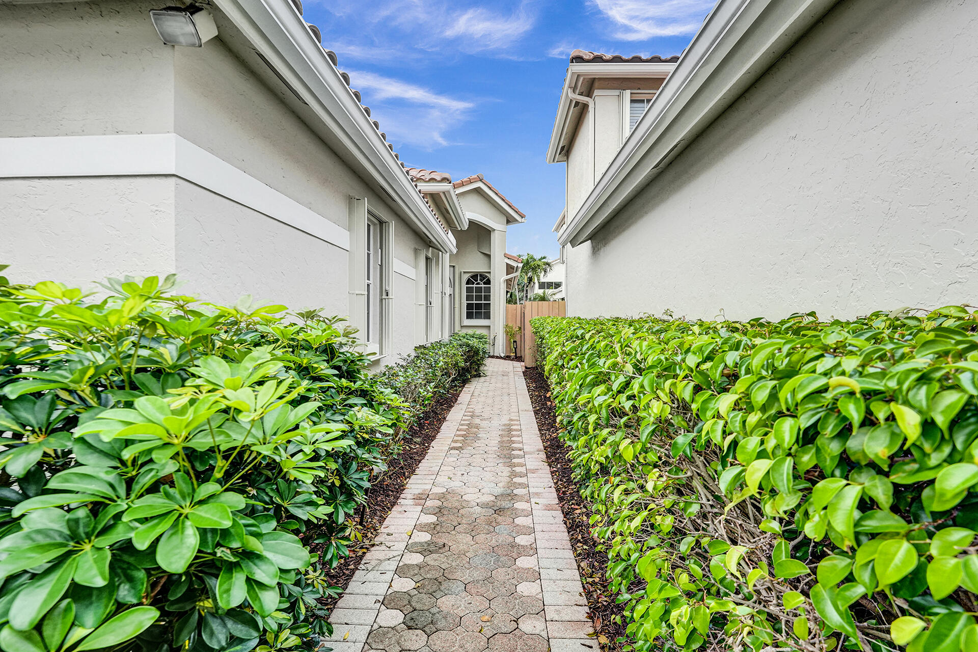 6675 Northwest 25th Way Boca Raton, FL 33496 - Photo 3 of 54 a view of a pathway with plants