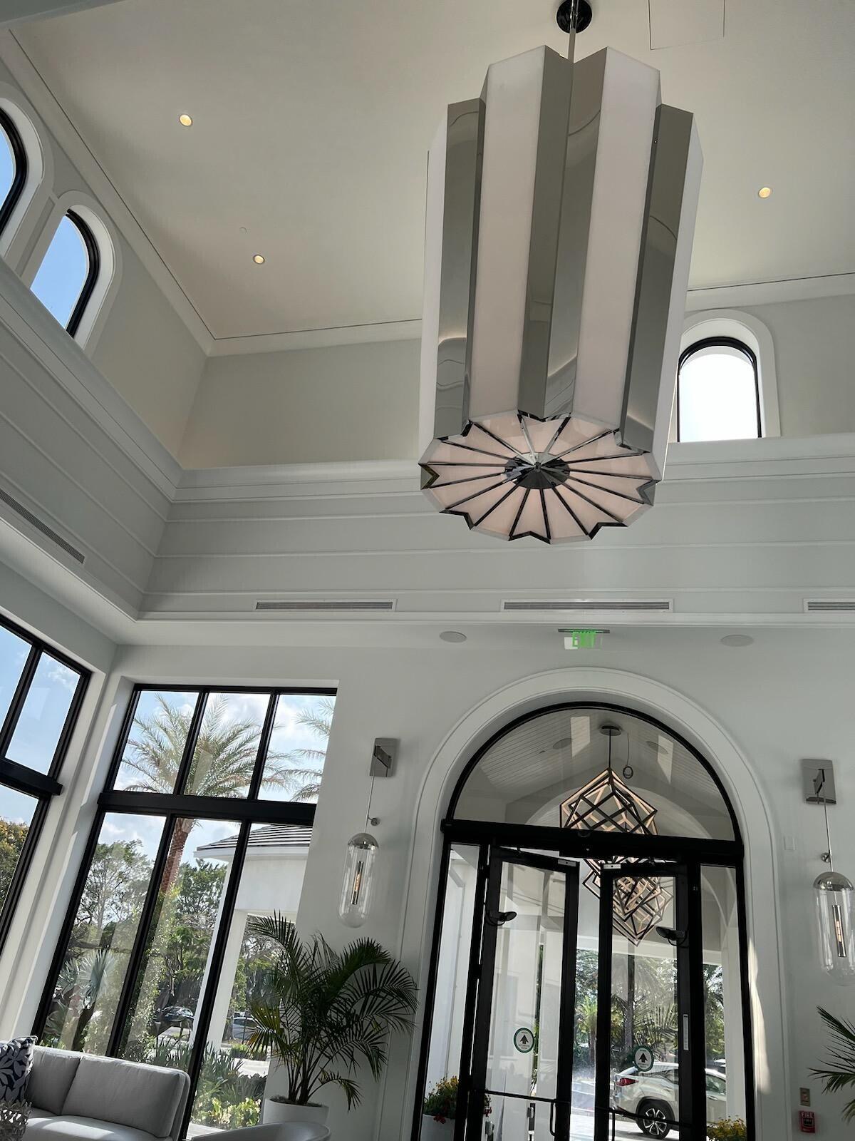 6675 Northwest 25th Way Boca Raton, FL 33496 - Photo 39 of 54 a view of staircase with a large window and potted plant on the wall