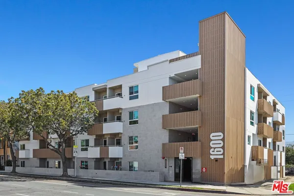 a front view of a building with a garden