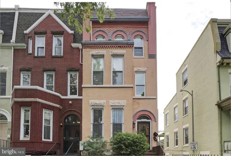 a view of a brick house with large windows