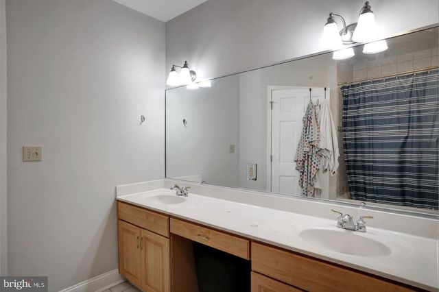 a bathroom with a sink vanity and a mirror