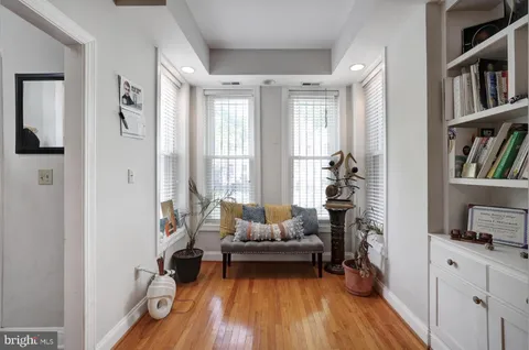a living room with furniture and a book shelf