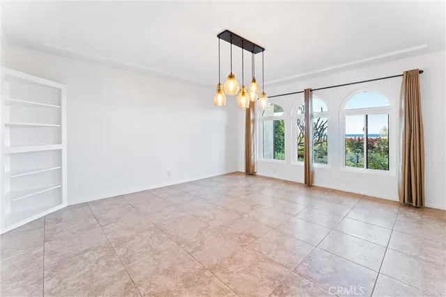 a kitchen with granite countertop cabinets a stove a sink and a chandelier