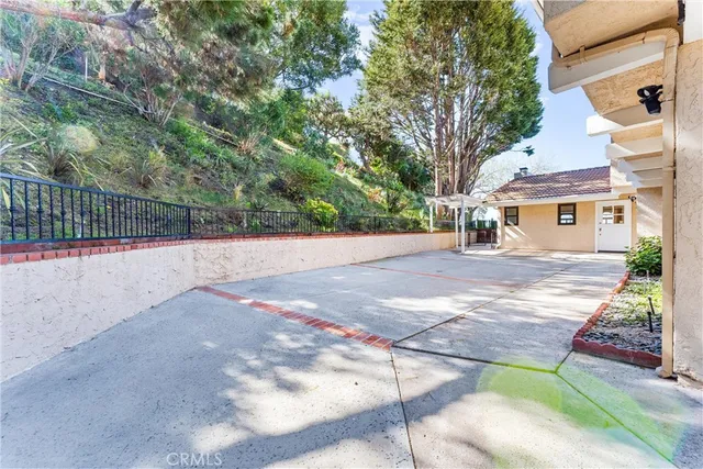 a view of empty room with wooden floor and ceiling fan