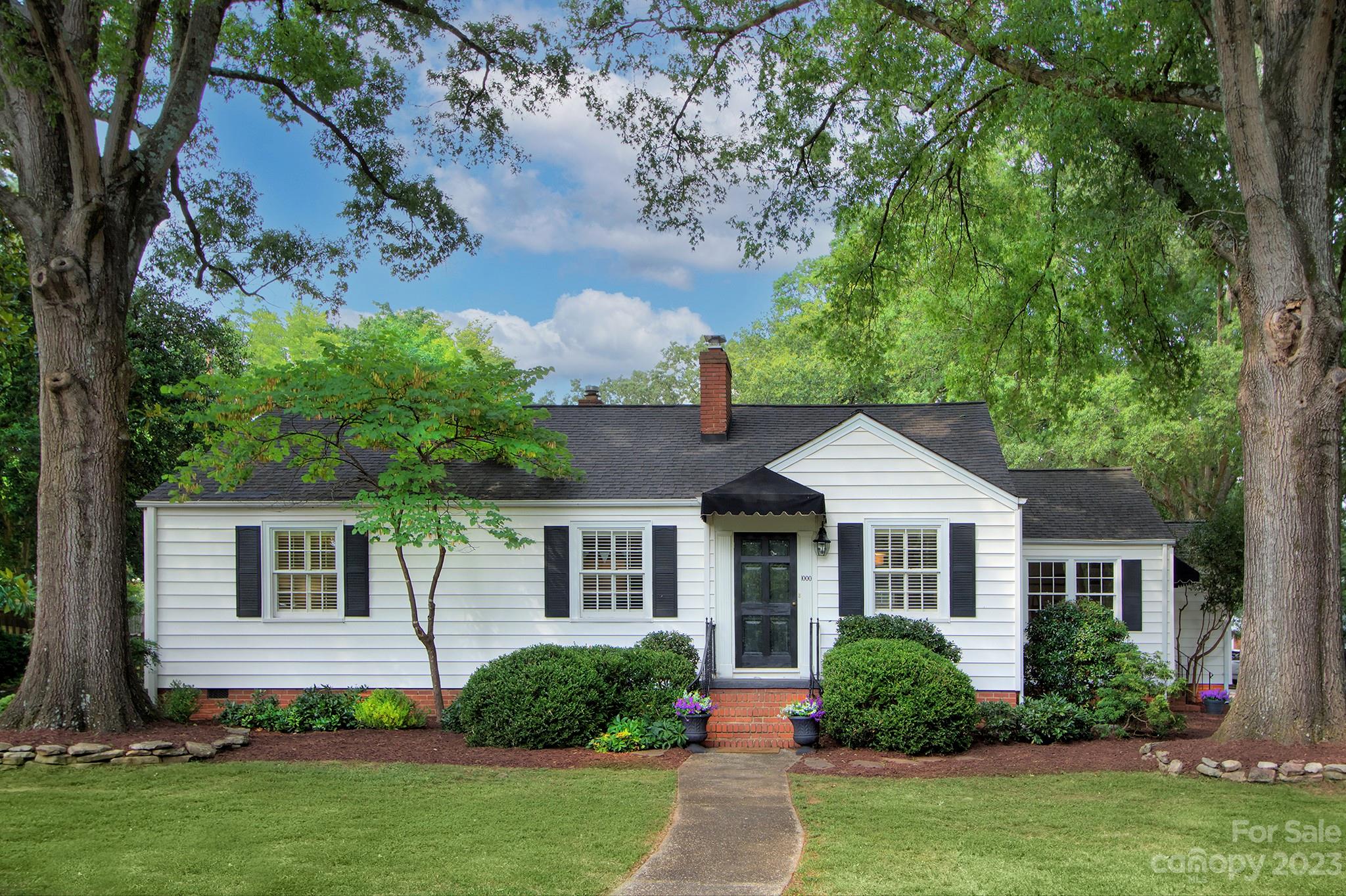 1000 Sedgefield Road Charlotte, NC 28209 - Photo 1 of 29 a front view of a house with a garden and plants