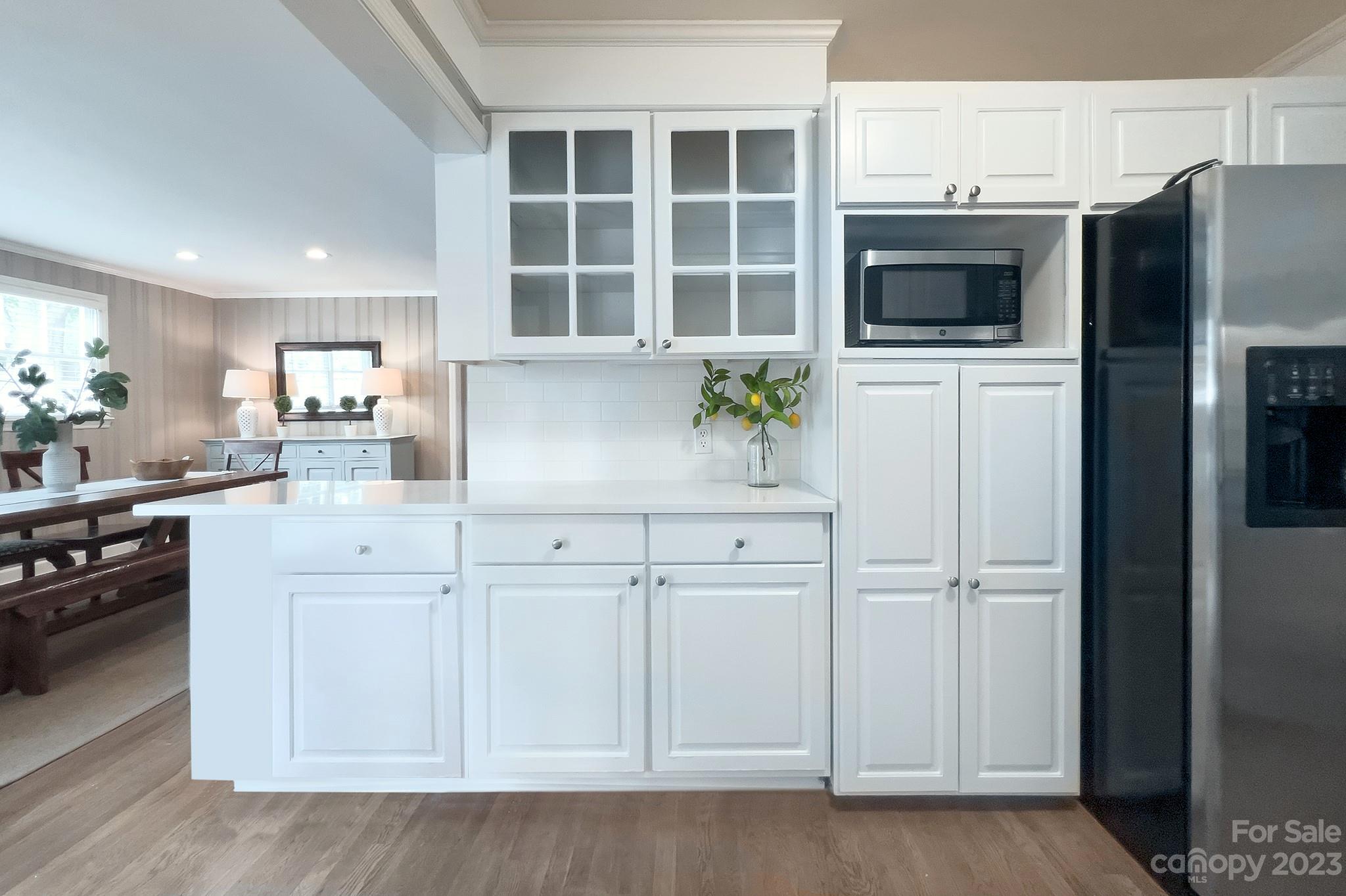 1000 Sedgefield Road Charlotte, NC 28209 - Photo 14 of 29 a kitchen with stainless steel appliances white cabinets and a refrigerator