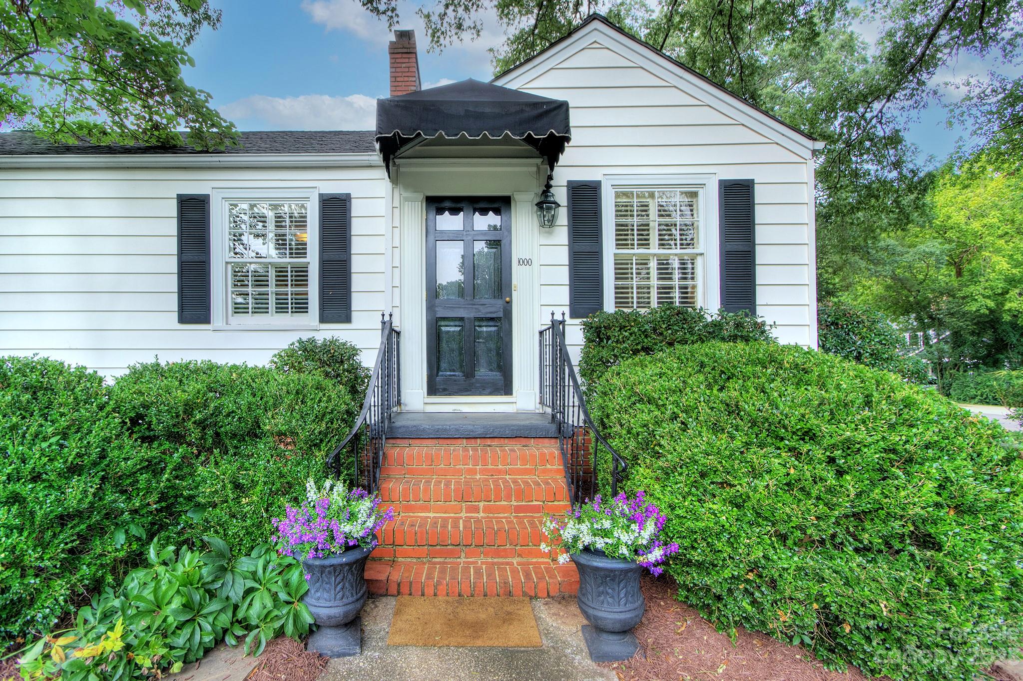 1000 Sedgefield Road Charlotte, NC 28209 - Photo 3 of 29 a house with flowers in front of it